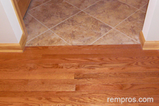 solid-prefinished-hardwood-floor-in-transition-with-porcelain-tile
